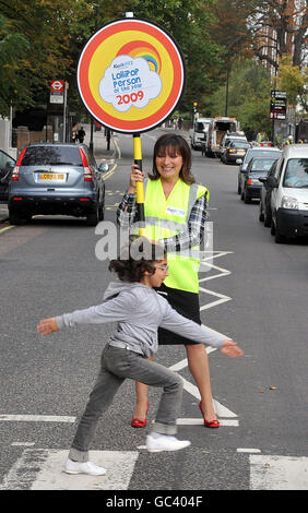 TV presenter Lorraine Kelly stops the traffic with Anita Babakandiat at the Abbey Road pedestrian crossing, in London, during the launch of the Lollipop Person of the Year Awards 2009. Stock Photo