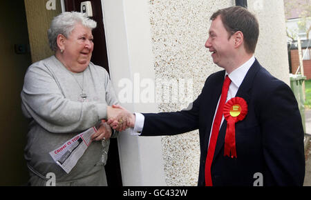 Glasgow North East by-election candidate Willie Bain (right) meets local resident Theresa Veitch on the campaign trail on Warriston Street in Glasgow. Stock Photo