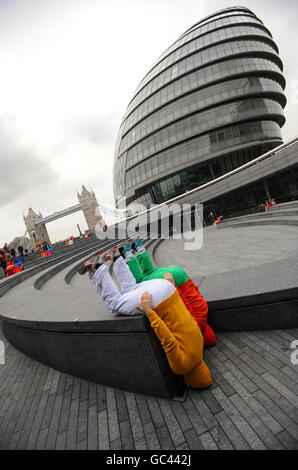 Bodies in Urban Spaces, a human artwork by Austrian artist Willi Dorner, near the Mayor's Office on London's Southbank today. The 'moving body trail', featuring 24 performers, is taking place in the Tower Bridge area until Sunday. Stock Photo