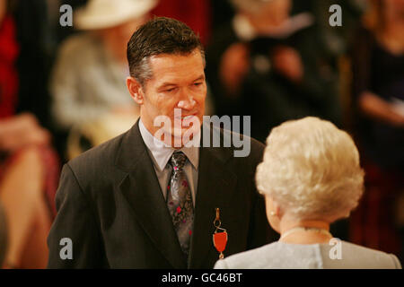 Graeme Hick receives his Member of the British Empire medal (MBE) Knighthood from Queen Elizabeth II at an Investiture ceremony at Buckingham Place, London. Stock Photo