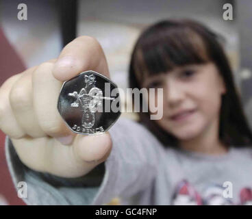 Florence Jackson, 9, from Bristol holds up a 50 pence coin featuring her design celebrating London 2012. She is the first child to work with the Royal Mint to design a UK coin after taking part in a CBBC Blue Peter competition. Stock Photo