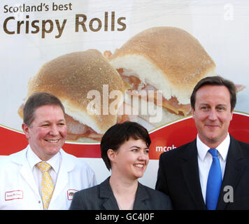 Conservative leader David Cameron joins Ruth Davidson Tory candidate for the Glasgow North East by-election and McGhee's employee Gordon McGhee on the campaign trail at McGhee & Sons bakery in Glasgow. Stock Photo