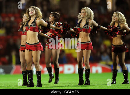 Tampa Bay Buccaneers NFL Cheerleaders entertain the crowd prior to kick off during the Coca-Cola Championship match at Vicarage Road, London. Stock Photo