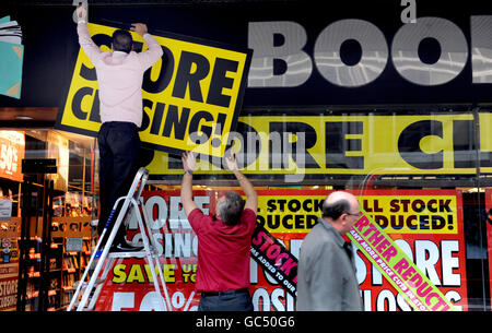 A store closing sign is hung outside a book shop on Victoria Street, London. Stock Photo