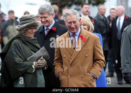 The Prince of Wales and the Duchess of Cornwall meet Prime Minister Stephen Harper (behind) during a visit to the Cupids Cove Plantation Archaeological site as part of their visit to Canada. Stock Photo