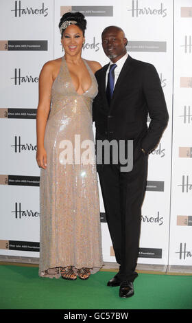 Kimora Lee Simmons (left) and Djimon Hounsou arrive for the Emerald Ball, in support of the Elton John AIDS Foundation, at Harrods department store in Knightsbridge, London. Stock Photo