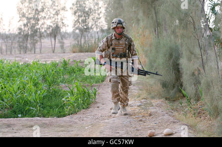 Lance Corporal Joe Jacobs from the Coldstream Guards on foot patrol while mentoring the Afghan National Army in an area west of Lashkar Gah near to Patrol Base Bolan, Afghanistan. Stock Photo