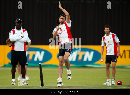 England's Sajid Mahmood (centre) bowls watched by coach Ottis Gibson (left) and Graham Onions (right) during the nets session at the De Beers Diamond Oval, Kimberley, South Africa. Stock Photo