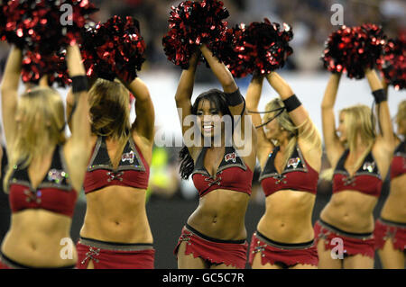 Tampa Bay Buccaneers' cheerleaders entertain the crowd before the start of the NFL match at Wembley Stadium, London. Stock Photo