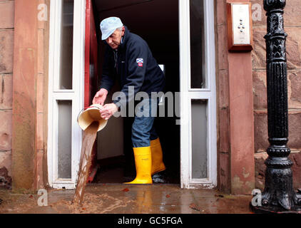 Locals clear their houses on Stonehaven High Street in Aberdeenshire, after the river Carron burst its banks causing flooding in the coastal town. Stock Photo