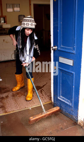 Locals clear their houses on Stonehaven High Street in Aberdeenshire, after the river Carron burst its banks causing flooding in the coastal town. Stock Photo