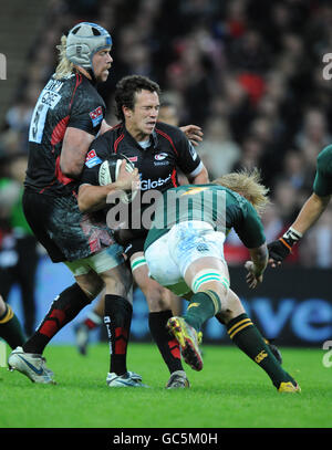 Rugby Union - Friendly - Saracens v South Africa - Wembley Stadium. Saracens' Derick Hougaard tackled by South Africa's Dewald Potgieter Stock Photo