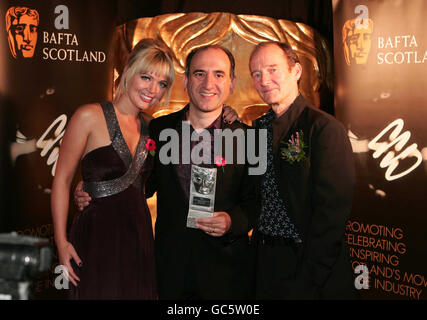 Isla Traquair and Armando Iannucci (centre) collect the award for Peter Capaldi with David Hayman at the 2009 BAFTA Scotland Awards at the Glasgow Science Centre. Stock Photo