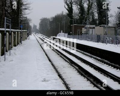 Empty platforms and snow covered rails at West Malling station in Kent, as swathes of Britain were hit by a fresh wave of snow. Stock Photo