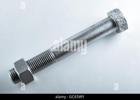 Big screw with nut isolated on background. Stock Photo