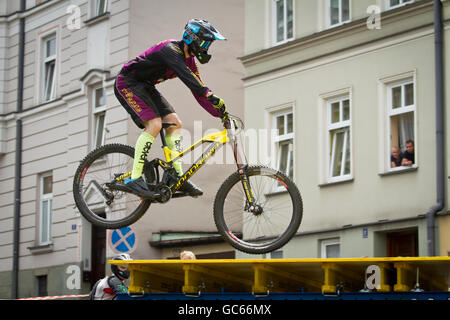 Downhill city tour. Biker jumps over the ramp during mountain bike race on the streets of Cieszyn. Poland. Stock Photo