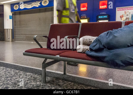 An unidentified homeless man sleeping overnight at Gatwick Airport. Stock Photo