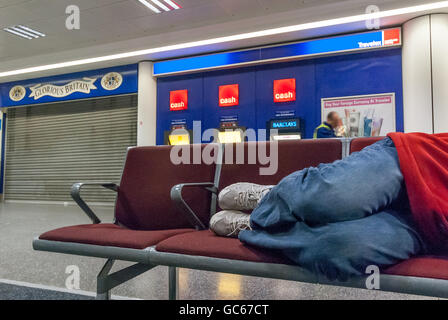 An unidentified homeless man sleeping overnight at Gatwick Airport. Stock Photo