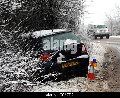 Winter weather Jan20th. Car in a roadside hedge near Tetbury in Gloucestershire.