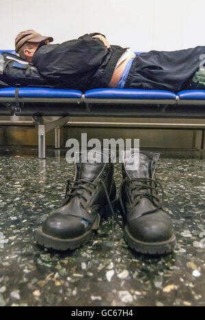 An unidentified homeless man sleeping overnight at Gatwick Airport. Stock Photo