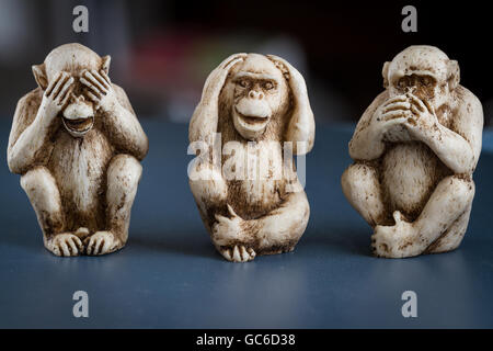 close up of hand small statues with the concept of see no evil, hear no evil and speak no evil. Stock Photo