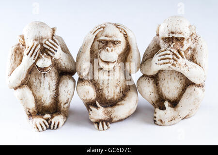 close up of hand small statues with the concept of see no evil, hear no evil and speak no evil. Stock Photo