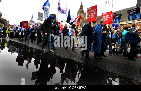 A group of protesters march past the Houses of parliament in Westminster central London, calling on World leaders to make climate change, at the United Nations Copenhagen Summit starting next week. Stock Photo