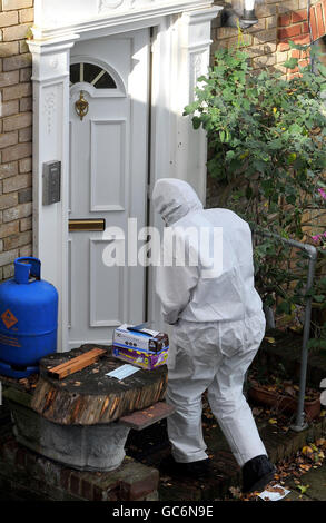 EDITORS PLEASE NOTE: NUMBER ON DOOR HAS BEEN REMOVED BY PA PICTURE DESK A Police forensic officer prepares to enter the home of Delroy Grant aged 52 from Brockley, south east London, who appeared in Court at Greenwich this morning, where he is accused of sexually assaulting elderly people during a series of burglaries over the past 17 years. Stock Photo