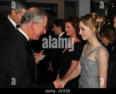 The Prince of Wales shakes hands with actress Saoirse Ronan, after he and the Duchess of Cornwall arrived at the Odeon Leicester Square in central London, for the Royal Film Premier of The Lovely Bones. Stock Photo