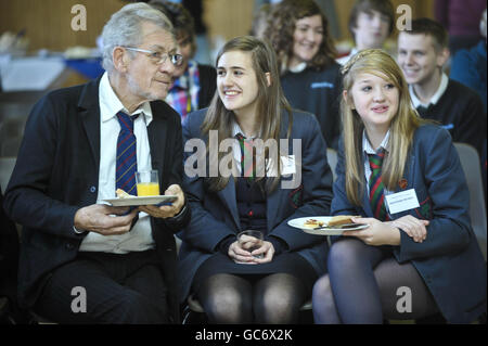 (Left - right) Sir Ian McKellan talks with Francesca Lane, aged 15, and her friend Alanna Collier-Cromwell, also 15, both from High School for Girls in Gloucester, who are visiting Severn Vale School to see a play with an anti-homophobic bullying message. Stock Photo