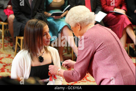 Swimmer Nyree Lewis receives an MBE for services to sport from The Queen at Windsor Castle. Stock Photo