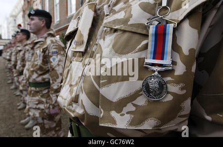 Soldiers from the 4th Battalion, The Mercian Regiment, stand to attention during a medal giving ceremony with The Prince of Wales, Colonel in Chief of the Mercian Regiment, at Clarence House where he presented campaign medals to the regiment. Stock Photo