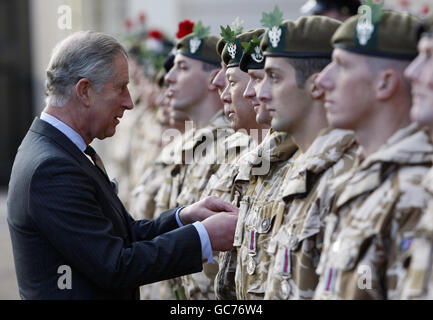 The Prince of Wales, Colonel in Chief of the Mercian Regiment, pins a medal on Captain John Lam (fourth right) from the 4th Battalion The Mercian Regiment at Clarence House where he presented campaign medals to the regiment. Stock Photo