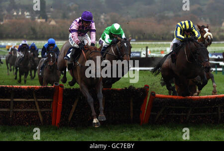 Time for Rupert ridden by William Kennedy (left) leads the field over the last on their way to victory in the Boylepoker.com Handicap Hurdle during the Boylesports International meeting at Cheltenham Racecourse, Gloucestershire. Stock Photo