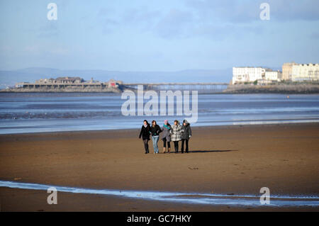 Walkers on the beach at Weston-super-Mare. Stock Photo