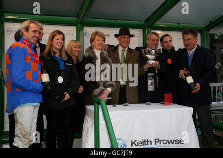 Jockey Ruby Walsh (left) and trainer Paul Nicholls (right) join the owners of Twist magic to celebrate their horses win in the Keith Prowse Hospitality Tingle Creek Steeple Chase Stock Photo