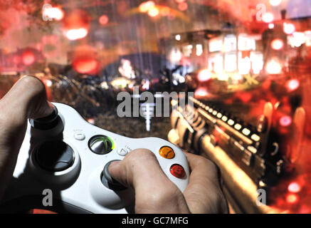 A person plays Call of Duty Modern Warfare 2 on the XBox 360. Stock Photo