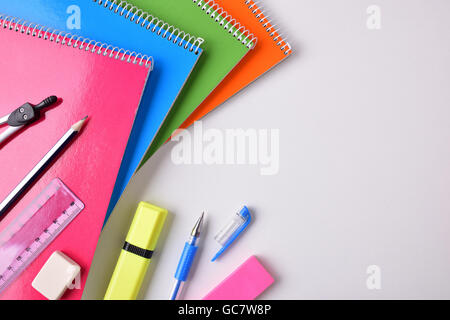 School material on white table to the left of the frame with place for title. Top view Stock Photo