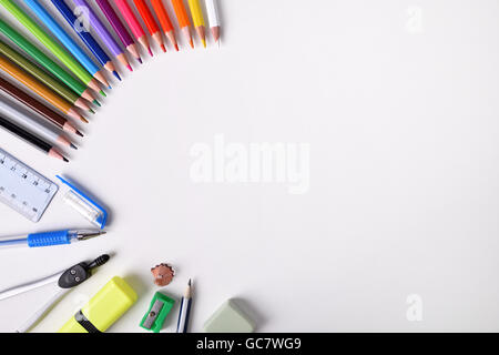 Student material on white table to the left of the frame with place for title. Top view Stock Photo