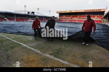 Groundstaff cover the frozen corner flag area of the pitch that meant the referee calling the game off against Norwich City at short notice before the Coca-Cola League One match at the Banks's Stadium, Walsall. Stock Photo