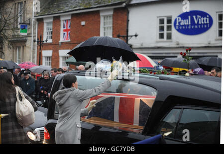 Mourners gather to pay their respects as three hearses containing the bodies of Lance Corporal Michael Pritchard, 22, of the 4th Regiment, Royal Military Police, Lance Corporal Christopher Roney, 23, of 3rd Battalion The Rifles and Lance Corporal Tommy Brown, of the Parachute Regiment, are carried through the streets of Wootton Bassett during their repatriation to the UK. Stock Photo