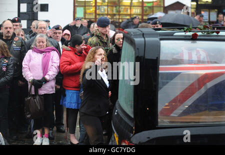 Mourners gather to pay their respects as three hearses containing the bodies of Lance Corporal Michael Pritchard, 22, of the 4th Regiment, Royal Military Police, Lance Corporal Christopher Roney, 23, of 3rd Battalion The Rifles and Lance Corporal Tommy Brown, of the Parachute Regiment, are carried through the streets of Wootton Bassett during their repatriation to the UK. Stock Photo