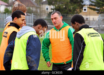 Malcolm Allen the former Watford, Newcastle United, Aston Villa and Wales striker, gives a tactical talk before a training session with young footballers in a local park in Watford, this morning. Stock Photo