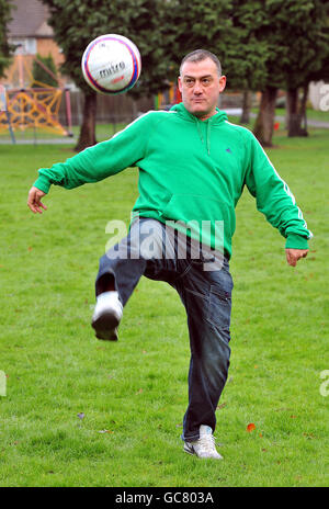 Malcolm Allen, the former Watford, Newcastle United, Aston Villa and Wales striker, warms up for a training session with young footballers in a local park in Watford, this morning. Stock Photo