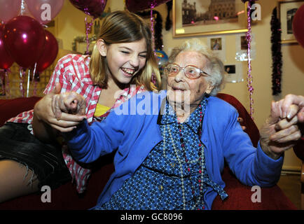 Mrs Ellen Watson, who today reached the age of 110, celebrates with family members including great great grand daughter Paige Hinde, 12, at her nursing home in Staines. Stock Photo