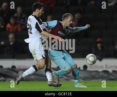 Milton Keynes Dons' Luke Howell and Burnley's Steven Fletcher battle for the ball during the FA Cup Third Round match at The Stadium:MK, Milton Keynes. Stock Photo