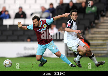 Burnley's Robbie Blake (left) and Milton Keynes Dons' Luke Howell battle for the ball Stock Photo