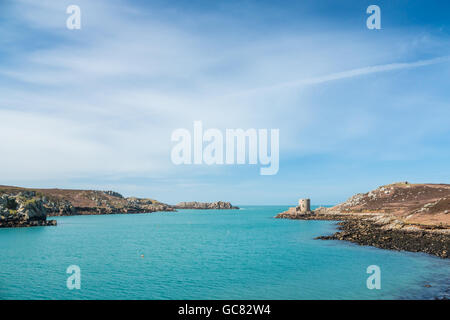 Cromwell's castle with blue sky and sea, Tresco, Isles of Scilly, March 2016 Stock Photo