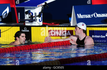 Great Britain's Michael Rock representing the E-Stars (right) shakes hands with USA's Michael Phelps after beating him in the Men's 200m Butterfly during The Duel in the Pool at the Manchester Aquatic Centre, Manchester. Stock Photo