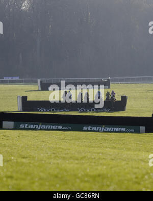 Runners and riders take a fence in the back straight in The coral.co.uk Hadicap Steeple Chase during the Coral Welsh National at Chepstow Racecourse, Gwent, Wales. Stock Photo